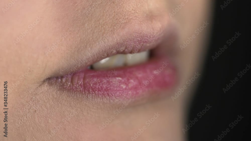 Make-up artist making professional make-up for young woman in beauty studio. Make up Artist applies lipstick on lips Make-up artist making professional make-up for young woman in beauty studio. Make up Artist applies lipstick on lips