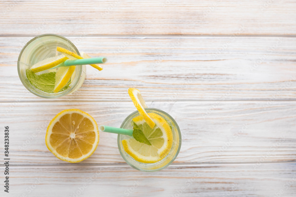 Summer drink lemonade on a white wooden table, top view, space for text Summer drink lemonade on a white wooden table, top view, space for text