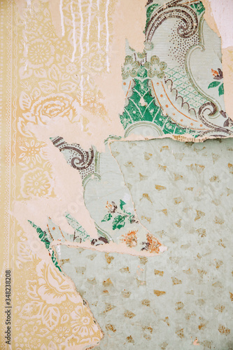 Vintage, old wallpaper, dripping paint, layers of different colorful paper backgrounds.