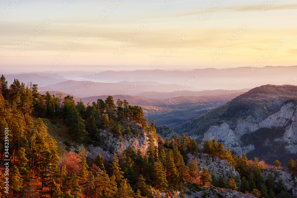 Rocky mountain valley at sunrise with a cloudy sky and fir trees. Big Thach Natural Park. krasnodar region, Russia