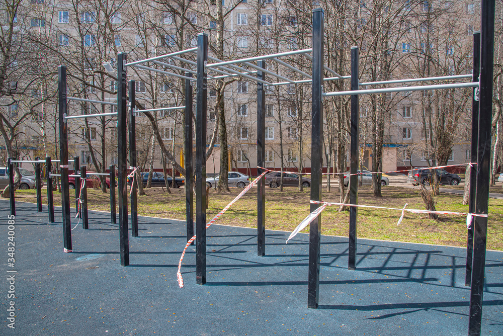 The Playground is closed on a Sunny day. Playground without children, covered with safety tape. Quarantine. The Playground is closed on a Sunny day. Playground without children, covered with safety tape. Quarantine.