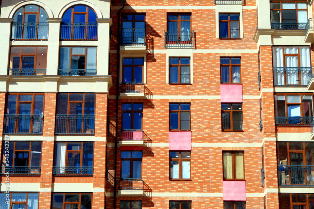 apartment Windows on the facade of a residential brick multi-storey building