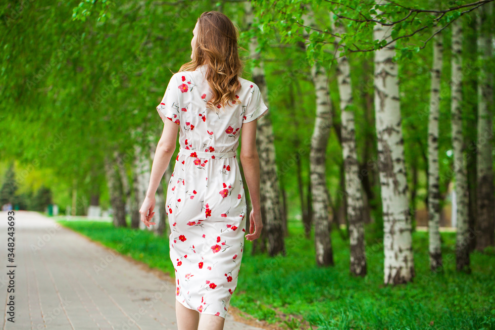 Portrait of a young beautiful blonde woman in white flowers dress Portrait of a young beautiful blonde woman in white flowers dress