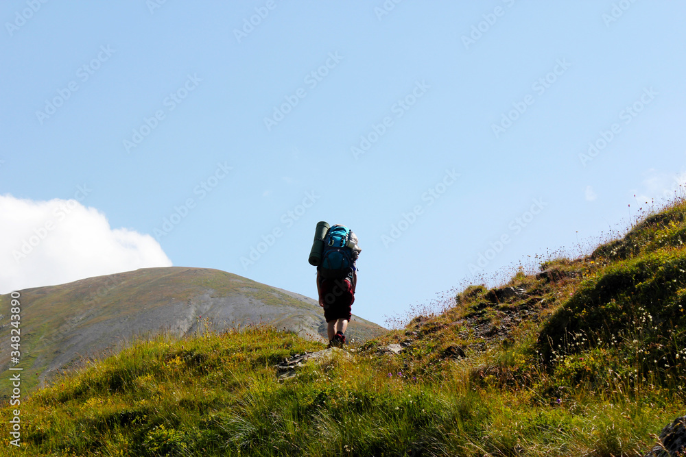 hiker walking in mountain track 