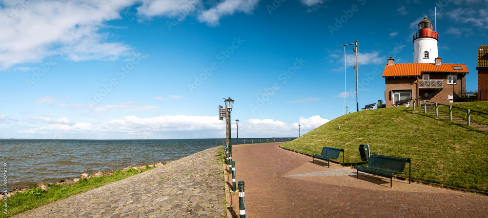 Urk Nehterlands, small fishing village Urk with is colorful lighthouse by the lake Ijsselmeer Netherlands Flevoland - obrazy, fototapety, plakaty 