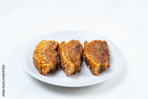 Deep Fried Crispy Streaky Pork Belly Thai and Chinese Food on White Plate on White Background Isolated.