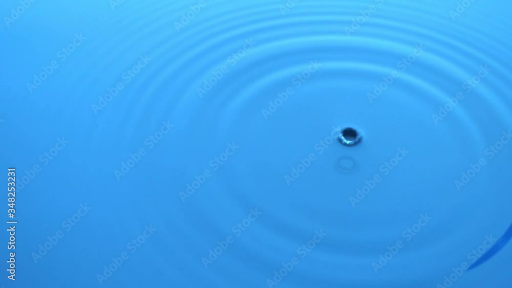 Drops falling in water leaving circles on the water. Slow motion Drops falling in water leaving circles on the water. Slow motion