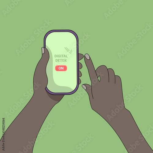 One black hand holds the phone, the other simulates clicking on the enable digital detox button.