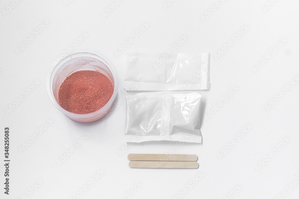 Close up of medical experiments. transparent jar, three pockets with reagents, medical gloves on isolated light background. Experiments for kids. Selective focus Close up of medical experiments. transparent jar, three pockets with reagents, medical gloves on isolated light background. Experiments for kids. Selective focus