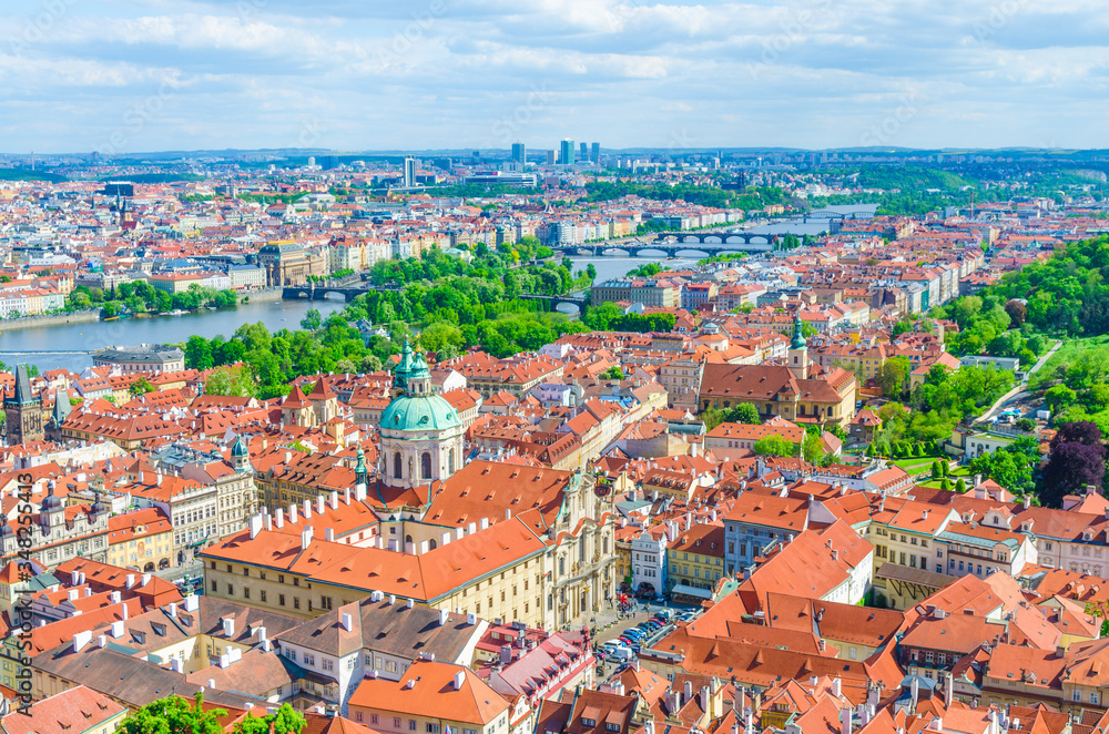 Top aerial panoramic view of Prague historical city centre with red tiled roof buildings in Mala Strana Lesser Town and Smichov districts, bridges over Vltava river, Bohemia, Czech Republic