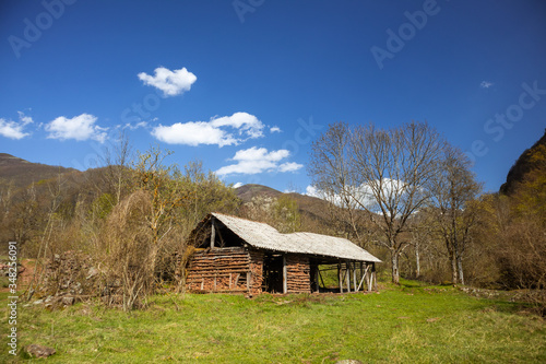 Old rustic idyllic houses in a village Topli do on Old Mountain (stara planina) in Serbia photo