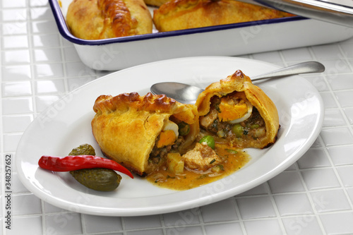 Canvas Print homemade saltena, empanada with a juicy filling, Bolivian breakfast