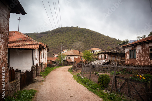 Old rustic idyllic houses in a village Topli do on Old Mountain (stara planina) in Serbia photo