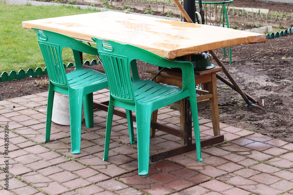 table and plastic green chairs in the country