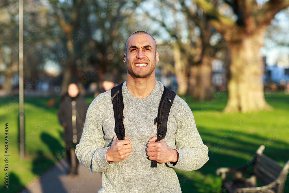 happy young man walking through the park happy young man walking through the park