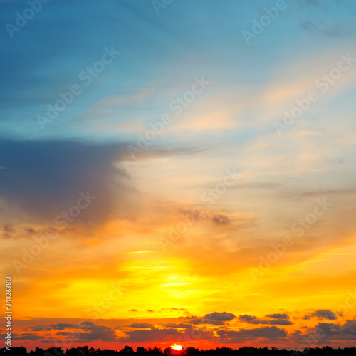 Cloudy sky and bright sunrise over the horizon.