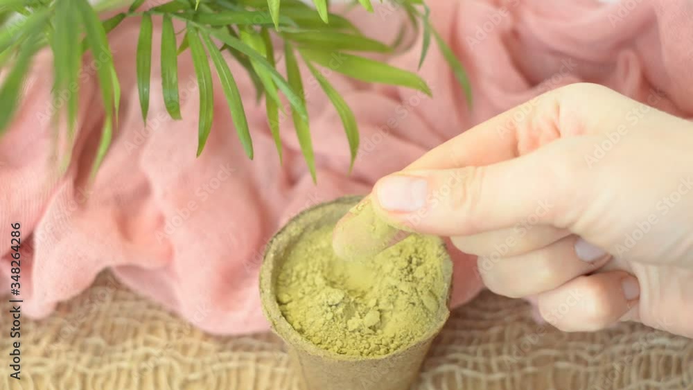 dry henna powder with female hands to rub without manicure. Natural materials. Eyebrow dyeing