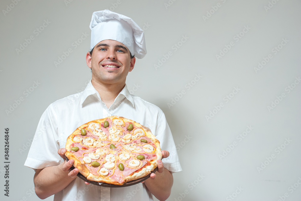 portrait cook with pizza on a light background portrait cook with pizza on a light background
