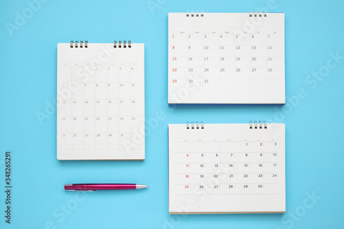 calendar page with pen close up on blue background business planning appointment meeting concept