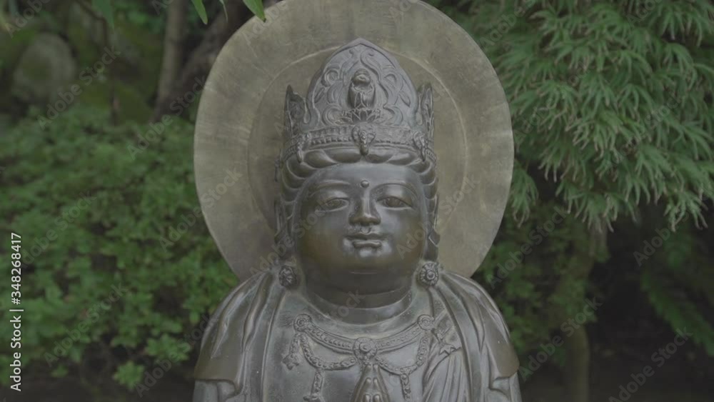 statue in japan standing in a park statue in japan standing in a park