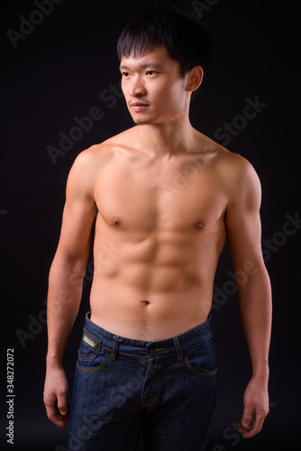 Portrait of young muscular Asian man shirtless