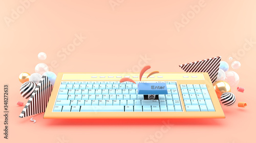 Enter the button out of the keyboard amid the colorful balls on the pink background.-3d rendering.