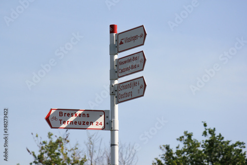 Dutch bicycle signpost in Breskens with shadow from the sun