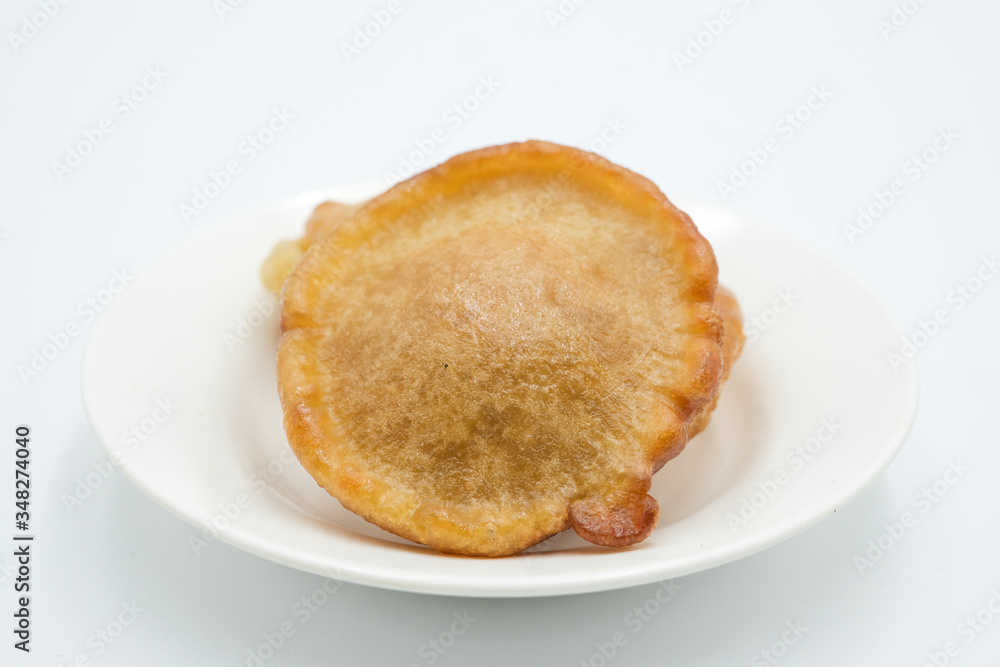 Pinjaram, penyaram of penjaram, a traditional bajau or suluk or sea bajau tribe traditional cuisines, shot on a white isolated background. Pinjaram, penyaram of penjaram, a traditional bajau or suluk or sea bajau tribe traditional cuisines, shot on a white isolated background.