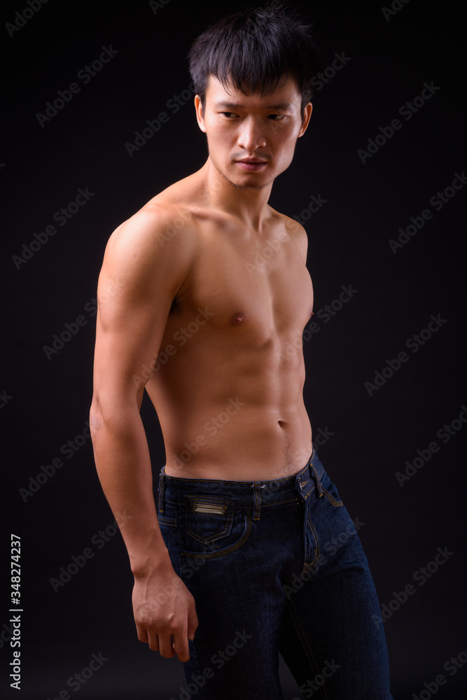 Fototapeta premium Portrait of young muscular Asian man shirtless
