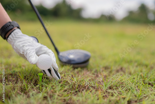 Portrait of golfer asian woman holding golf wood at the country club,Happy woman concept,Put golf on pin