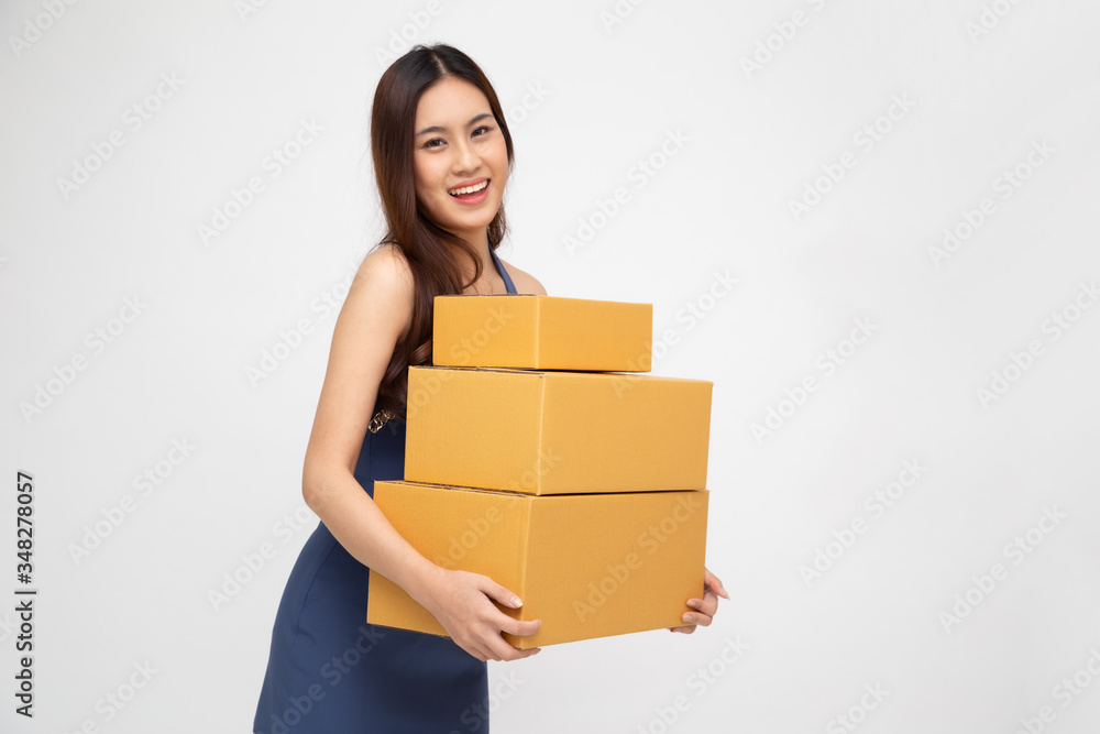 Happy Asian woman holding package parcel box isolated on white background, Delivery courier and shipment service concept Happy Asian woman holding package parcel box isolated on white background, Delivery courier and shipment service concept