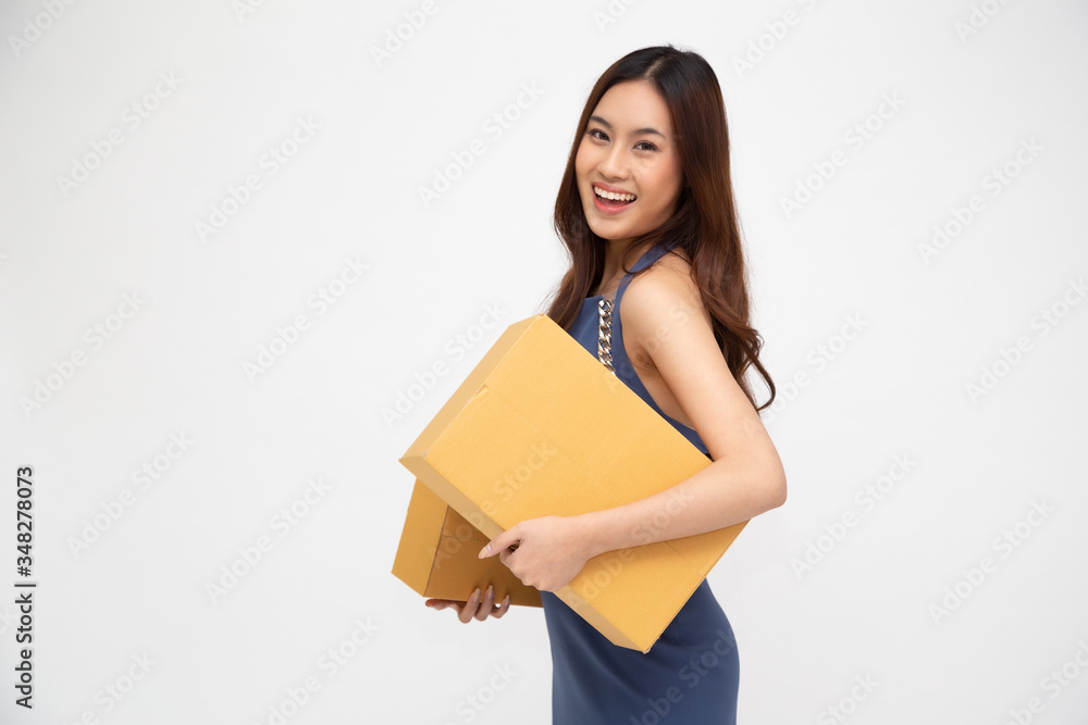 Happy Asian woman holding package parcel box isolated on white background, Delivery courier and shipment service concept Happy Asian woman holding package parcel box isolated on white background, Delivery courier and shipment service concept