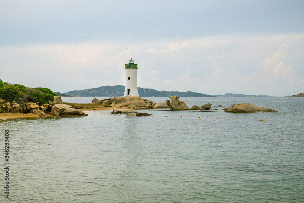 Small lighthouse at the shores of Mediterranean sea in small city of Palau