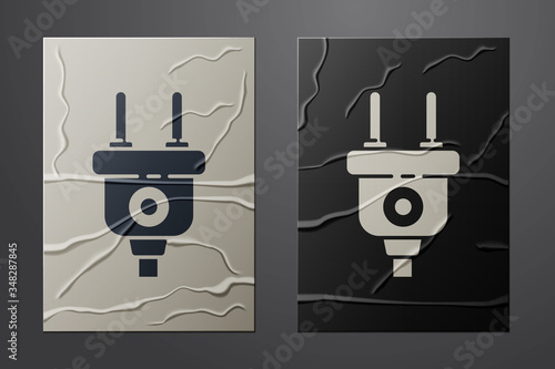 White Electric plug icon isolated on crumpled paper background. Concept of connection and disconnection of the electricity. Paper art style. Vector