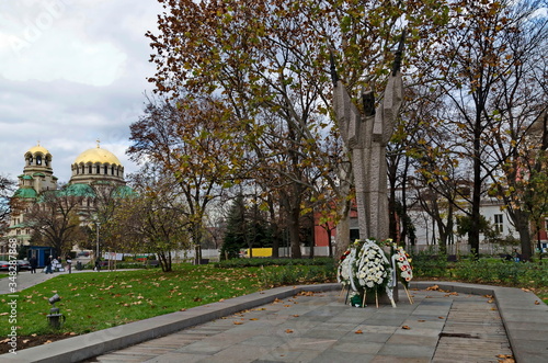 Statue of Kliment Ohridski in the city center on the background of the Golden domes of St. Alexander Nevsky Cathedral of Sofia, Bulgaria, Europe    photo