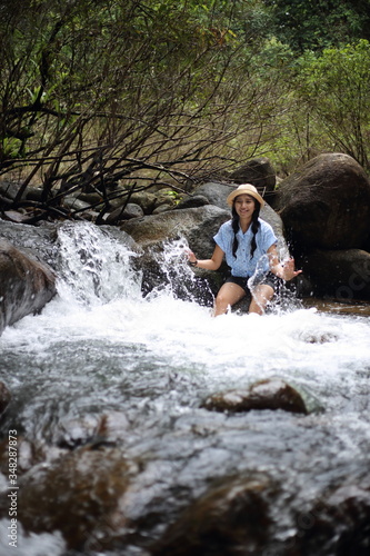 Woman soaking in the Trok Nong waterfall in Chanthaburi  Thailand