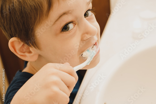 The child is brushing his teeth.