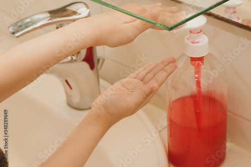 The child puts soap on his hands.