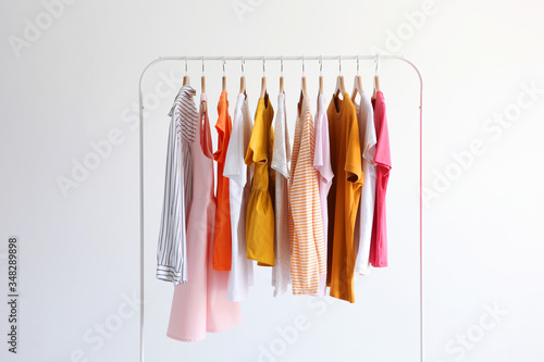fashion clothes on a stand in a light background indoors. place for text
