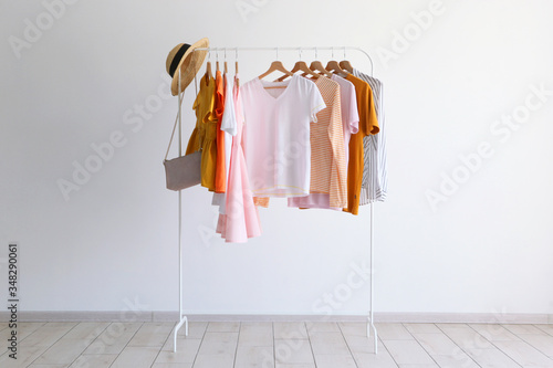 fashion clothes on a stand in a light background indoors. place for text 