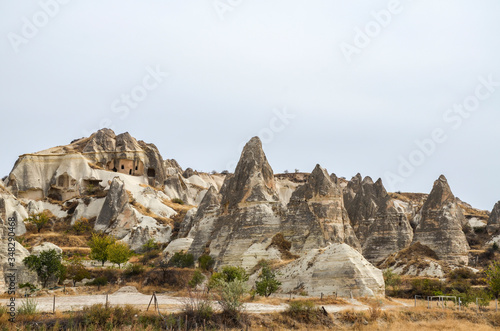 View to the exotic fairy chimney rocks formations and cave houses in Cappadocia, Turkey