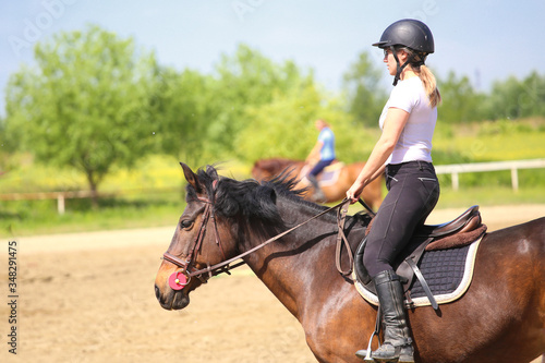 Training in the riding school, girl ride the sorrel horse © Geza Farkas