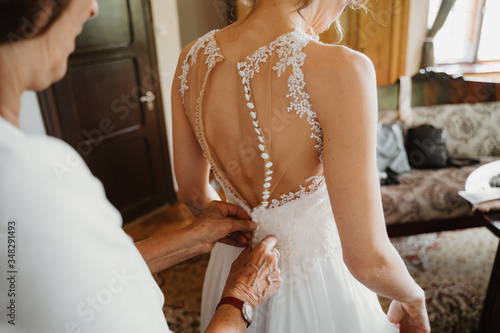 Photography photo of a bride getting ready wearing a dress