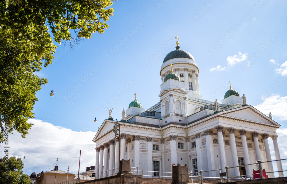Helsinki city cathedral with dome and golden crosses with back ground of cloudy blue sky, Finland