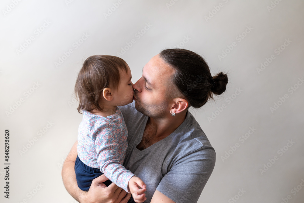 Father kiss his lovely and cute little daughter on white background. Father's Day conception