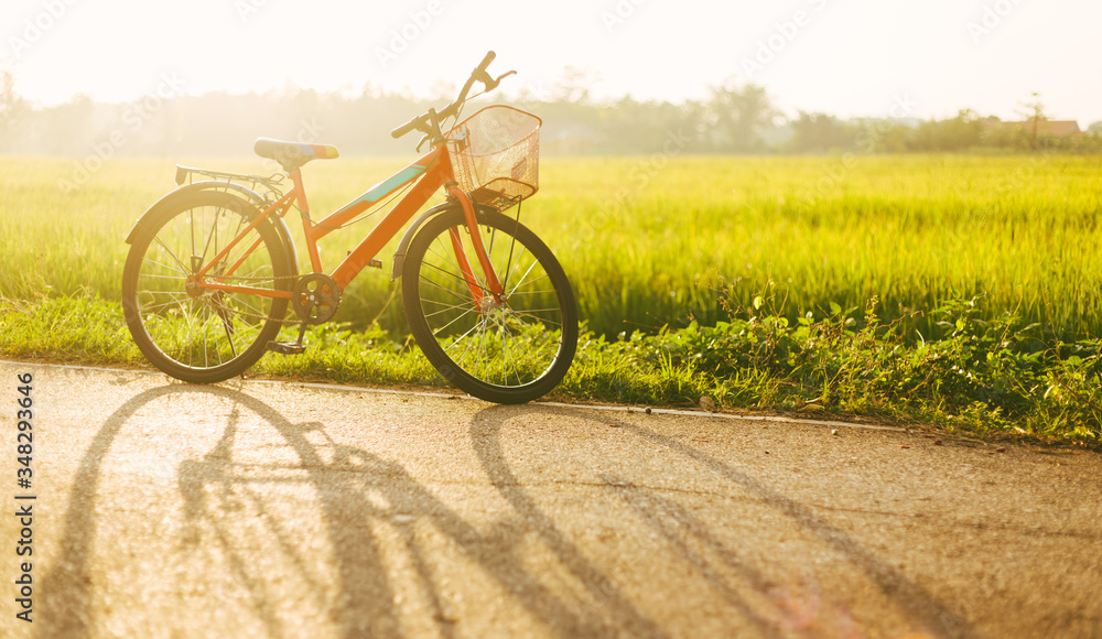 Beautiful field landscape image with red bicycle in sunset