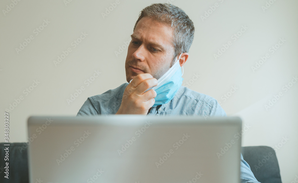 Man tired of wearing medical mask indoors. Man tired of wearing medical mask indoors.