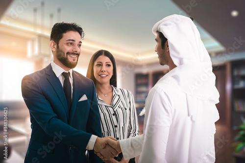 Tablou canvas Man in suit shake hand of Arabic business man as hello in office