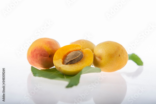 fresh apricots and leaves isolated background