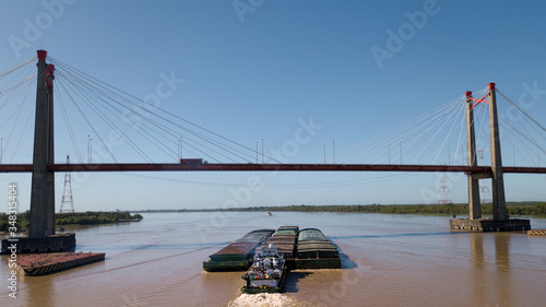 Long Arm Zarate Bridge, located in South America, Argentina, divides the province of Buenos Aires and Entre Rios. below this ship, cargo ships to Brazil and other destinations. photo